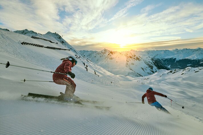 HochjochTotale - Silvretta Montafon | ©  Silvretta Montafon - Stefan Kothner Zwei Skifahrer fahren über die frisch präparierte Piste bei Sonnenaufgang bei der HochjochTotale in der Silvretta Montafon | ©  Silvretta Montafon - Stefan Kothner